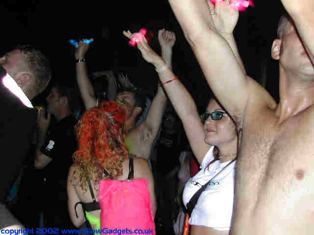 Glowsticks in the air at a rave