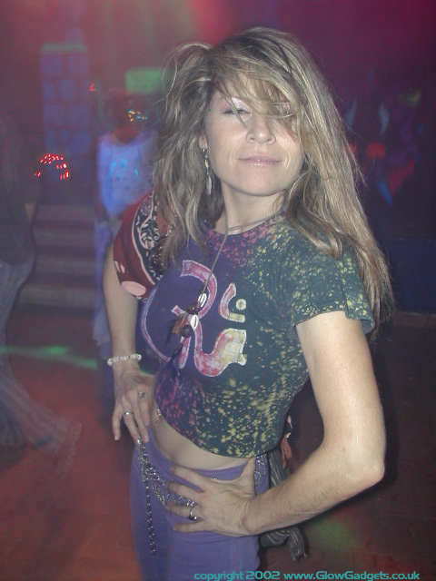 Reveller in wild UV-lit outfit
